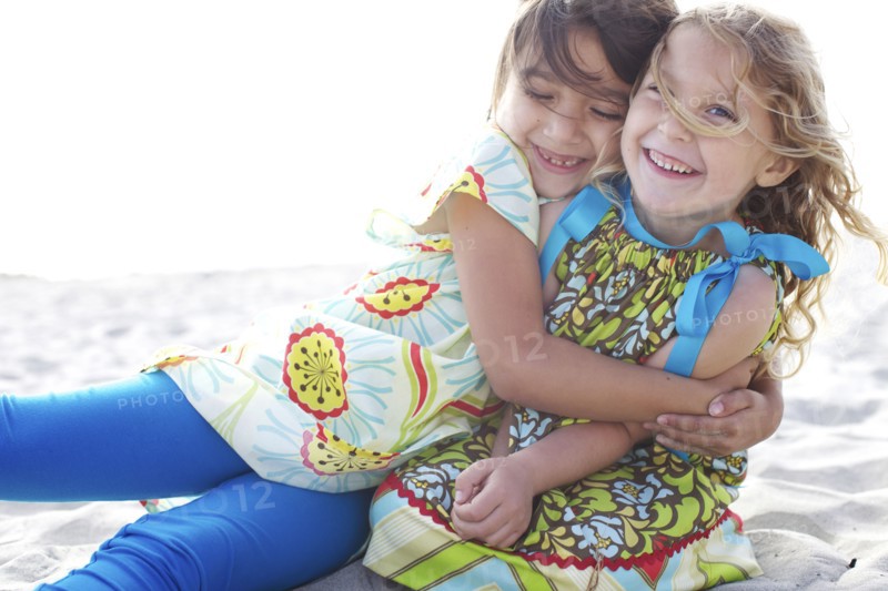 Children hugging on beach