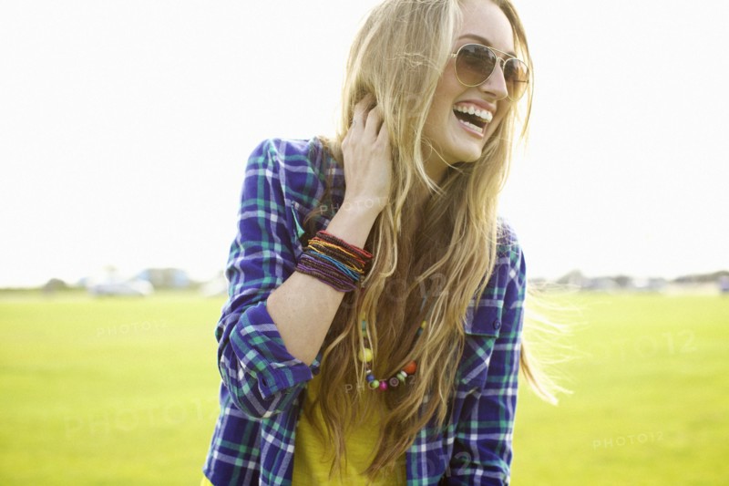 Laughing Caucasian woman standing in field