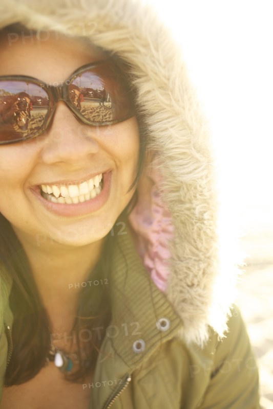 Smiling mixed race woman in fur hood