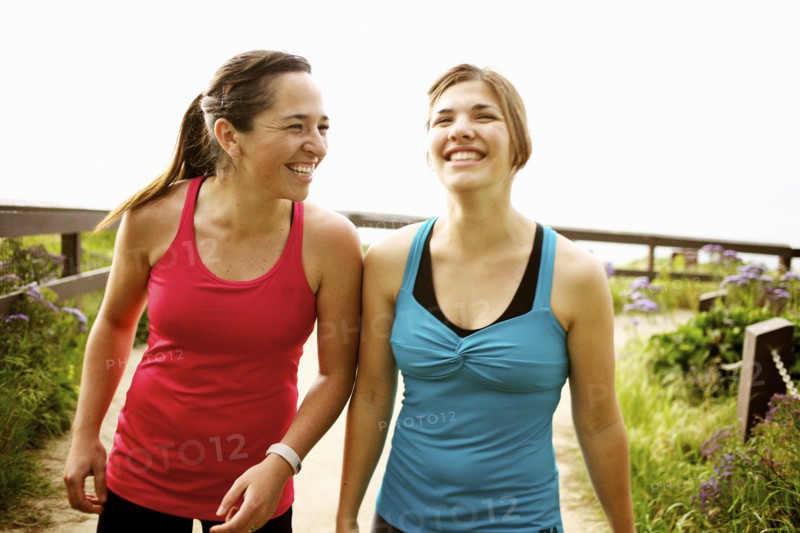 Laughing athletic friends standing together outdoors