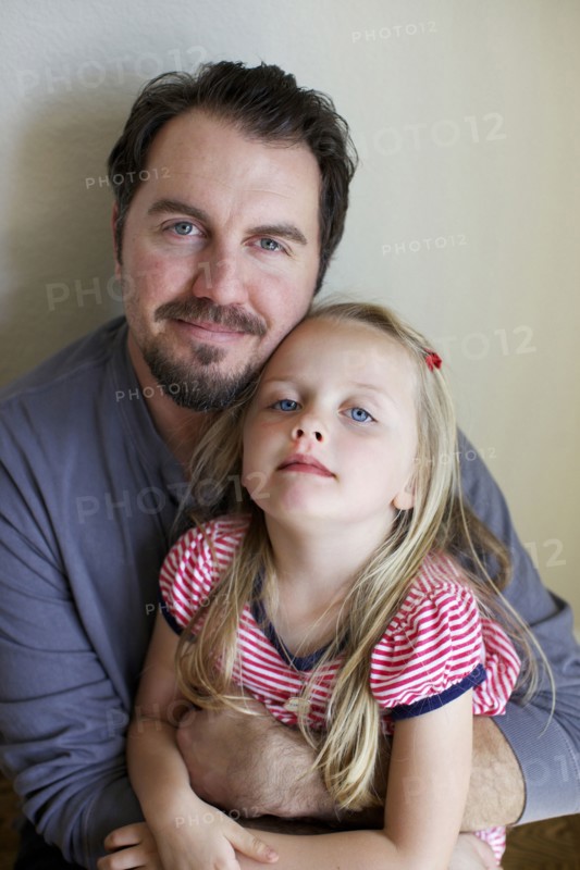 Father and daughter smiling