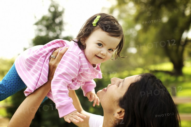 Mother holding toddler daughter