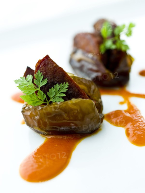 Close up of fig with chorizo in sauce
