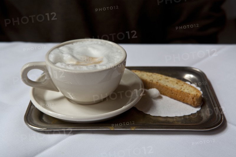 Latte and biscotti on tray