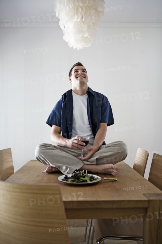 Caucasian man having dinner sitting on table