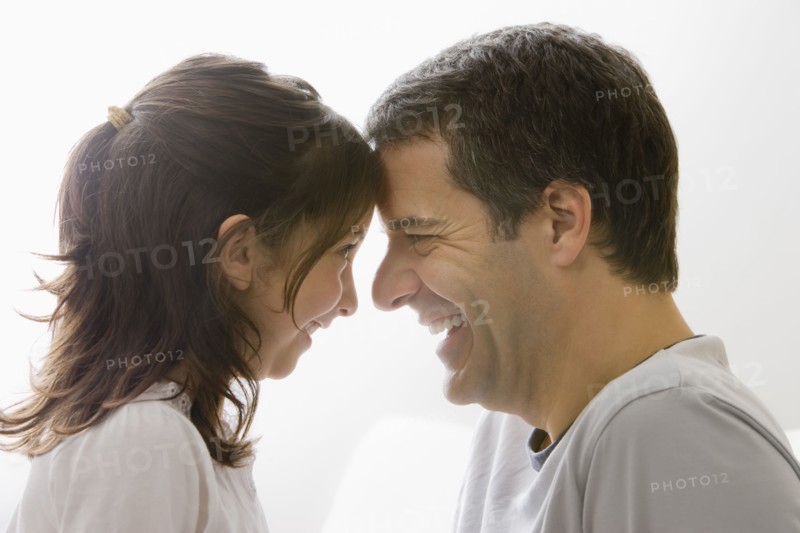 Hispanic father and daughter smiling