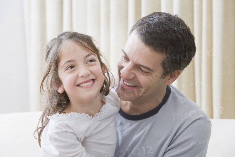 Hispanic father and daughter smiling