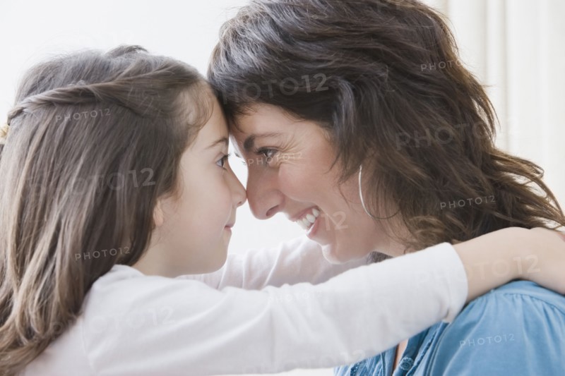 Hispanic mother hugging daughter