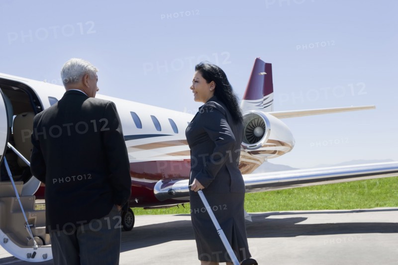 Business people boarding private jet
