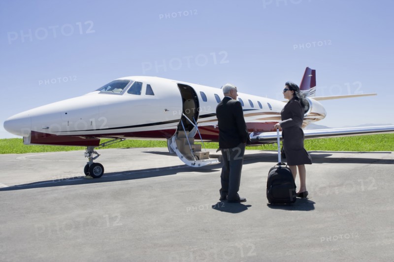 Business people boarding private jet