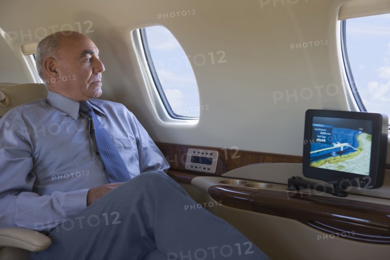 Hispanic businessman on private jet