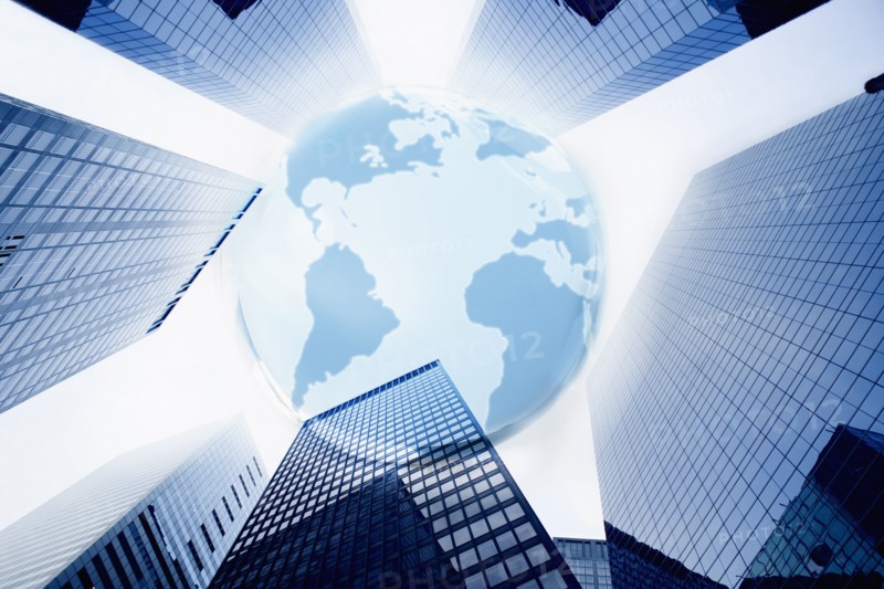 Large blue globe over highrise buildings