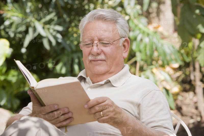 Senior Chilean man reading book