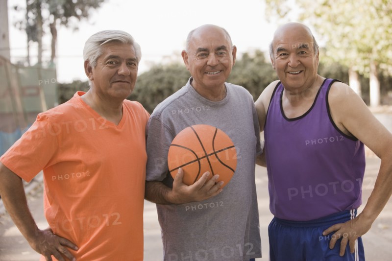 Senior Chilean men playing basketball together