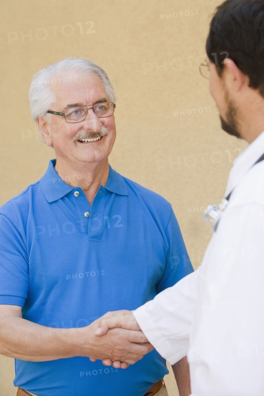 Senior man shaking hands with doctor