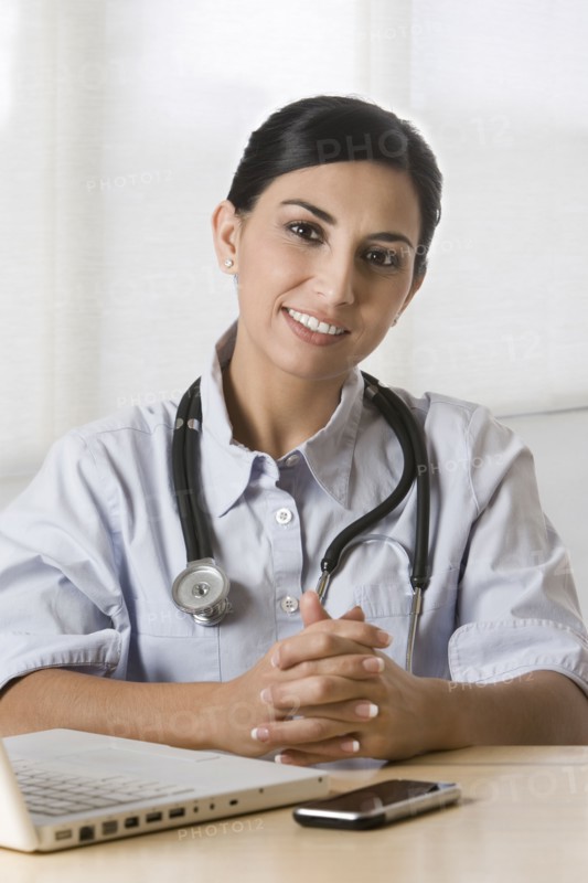 Turkish doctor sitting in doctor's office