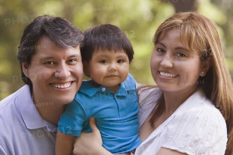 Smiling Hispanic parents holding baby boy