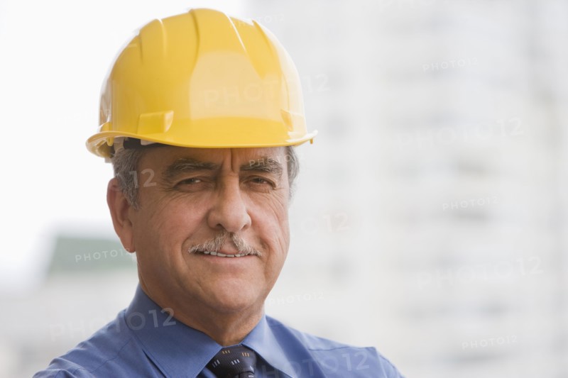 Hispanic businessman wearing hard hat