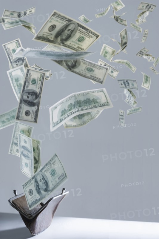 One hundred dollar bills floating out of purse
