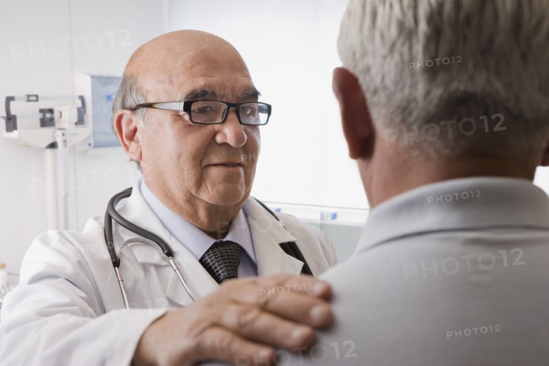 Hispanic doctor talking with patient