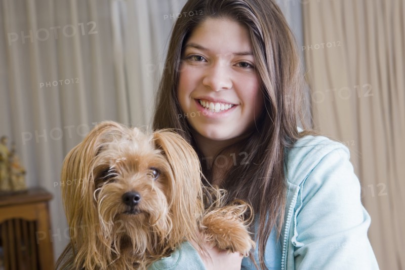 Hispanic girl holding dog