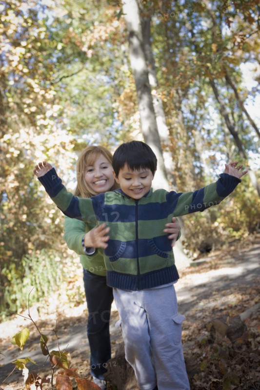 Hispanic mother and son playing in park