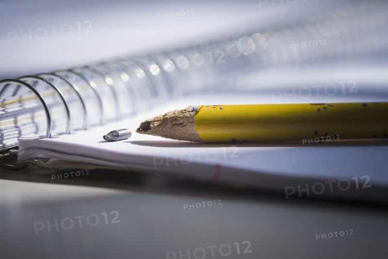 Close up of broken pencil on notebook