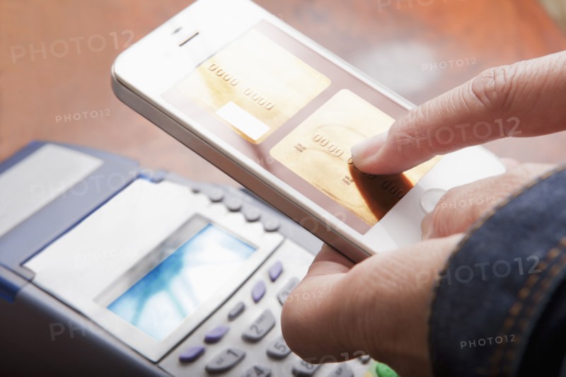 Hispanic woman paying with cell phone