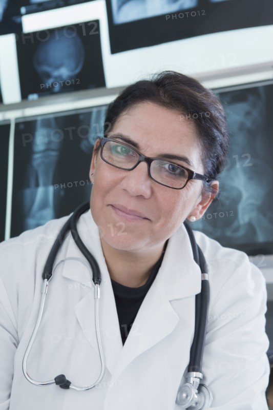 Hispanic doctor smiling in hospital
