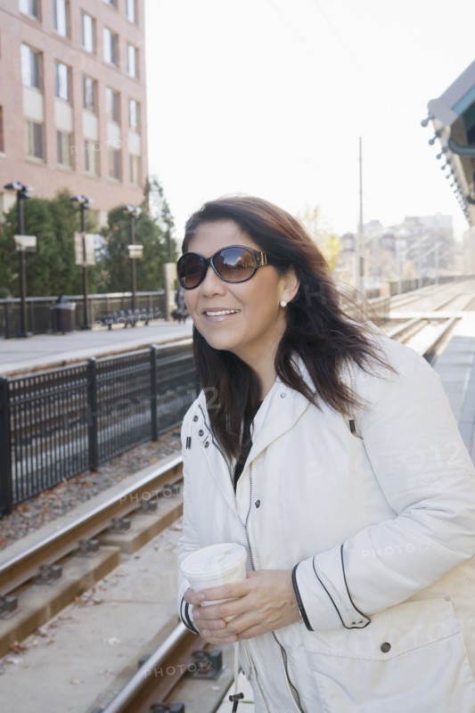 Hispanic woman waiting for train