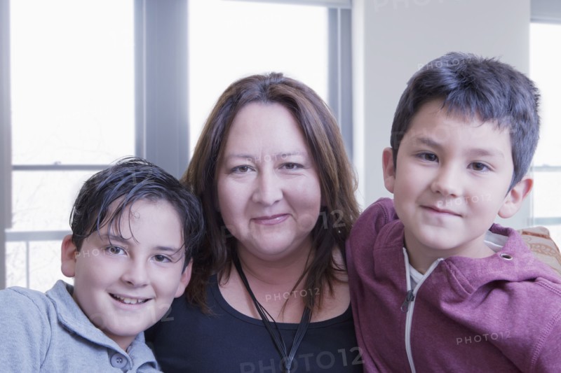 Hispanic mother posing with sons