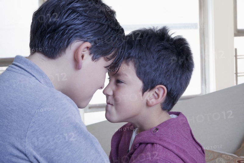 Hispanic brothers face to face with attitude