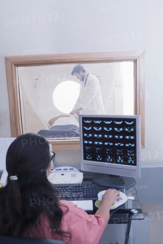 Hispanic nurse examining scanner results