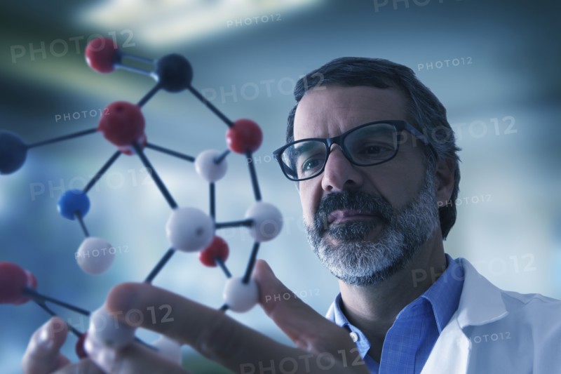 Hispanic scientist examining molecule model