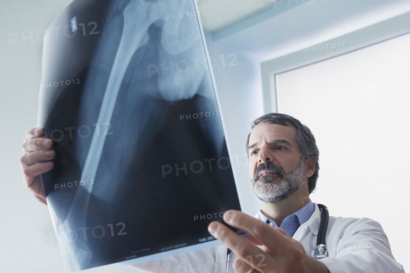 Hispanic doctor examining x-ray