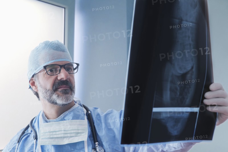 Hispanic surgeon examining x-ray