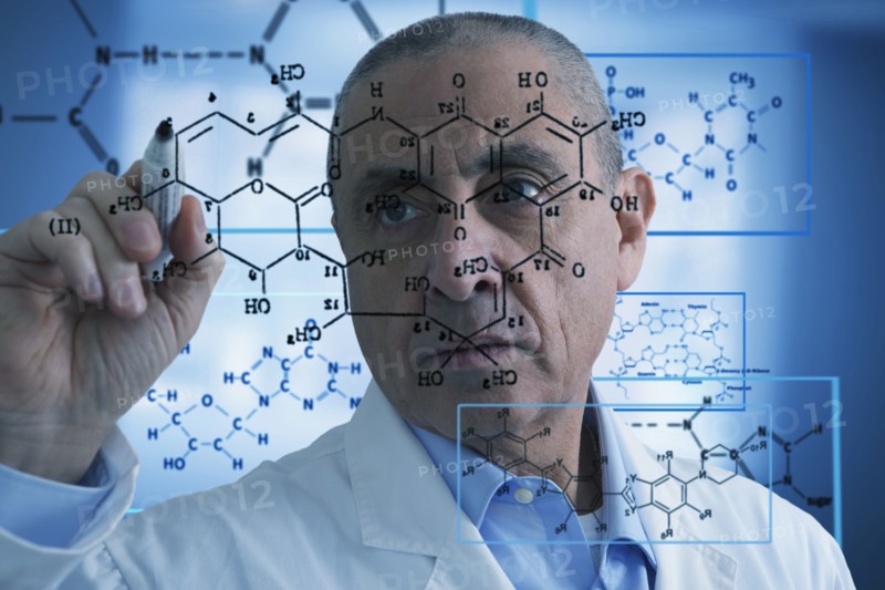 Hispanic scientist writing formula on glass wall