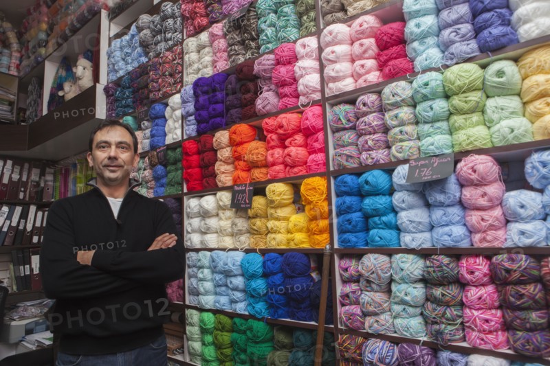 Mixed Race man posing at yarn store