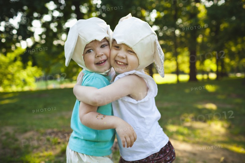 Smiling girls in mouse costume hugging