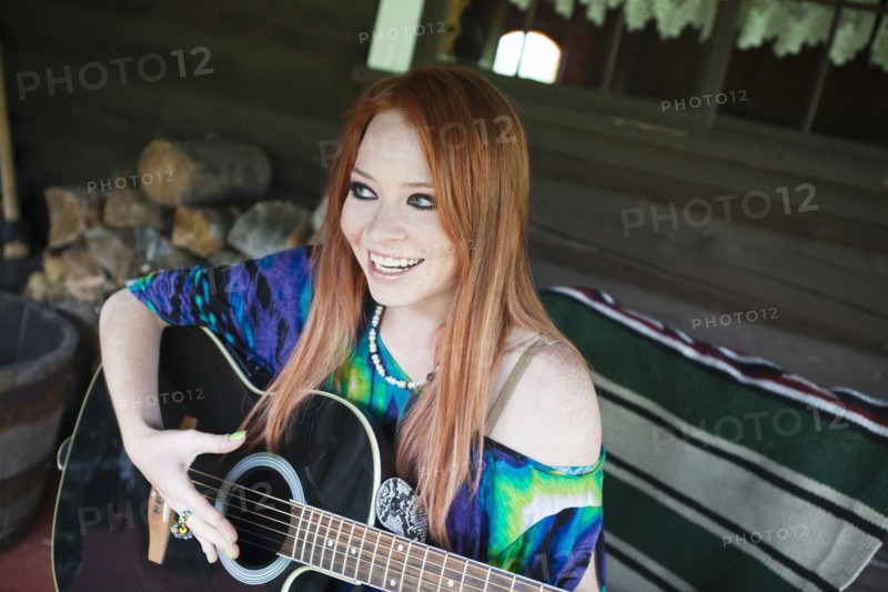 Caucasian woman playing guitar