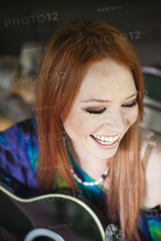 Caucasian woman playing guitar