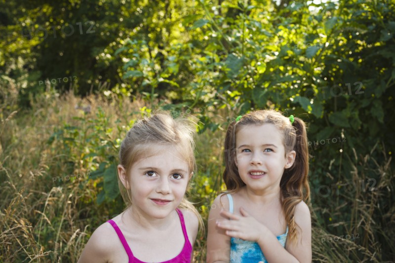 Caucasian girls standing in woods