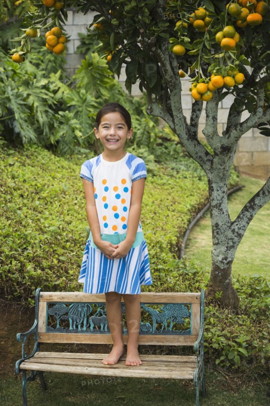 Mixed race girl smiling on park bench