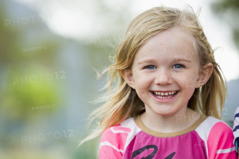 Smiling girl standing outdoors