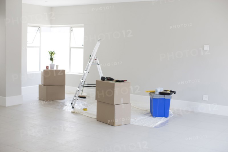 Cardboard boxes and ladder in new home