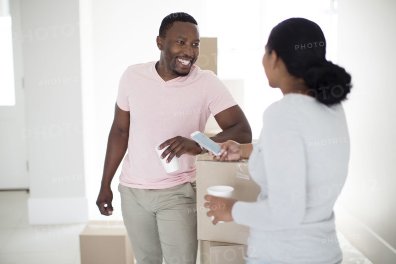 Couple with cardboard boxes in new home