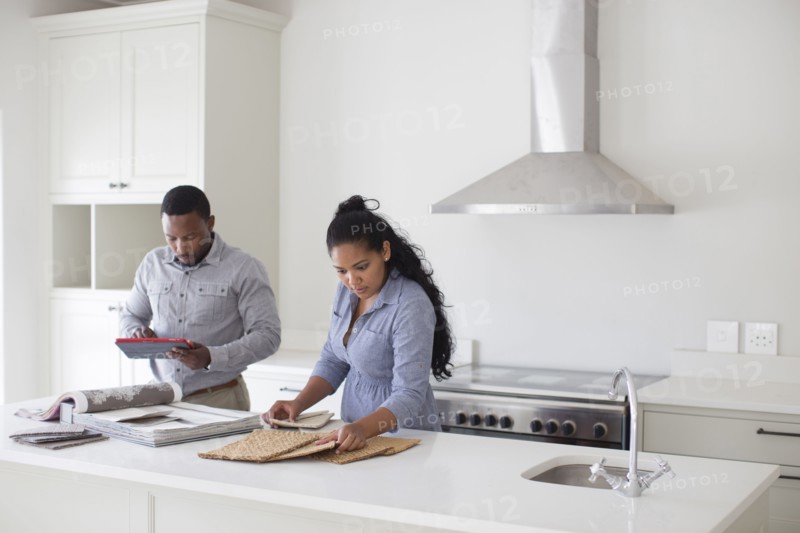 Couple examining fabric swatches in new home