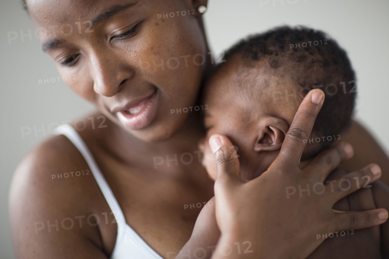 Close up of Black mother comforting baby