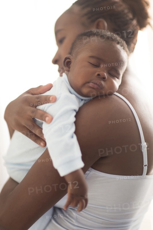 Close up of Black mother holding sleeping baby