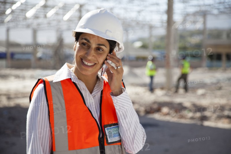Architect talking on cell phone at construction site
